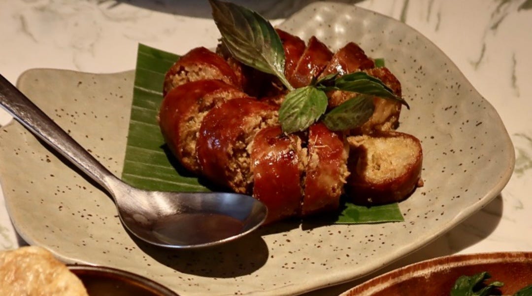 Also Burmese influenced, “sai ua” pork sausages are made with curry paste and an abundance of fresh herbs. Super delicate melt in your mouth filling and a casing that “pops” in a delightful way